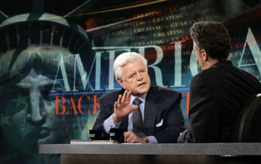 In this April 20, 2006 file photo, Sen. Edward M. Kennedy, D-Mass., left, makes an appearance on “The Daily Show with Jon Stewart” to promote his book, “America Back On Track”. (AP Photo/Stuart Ramson, File)