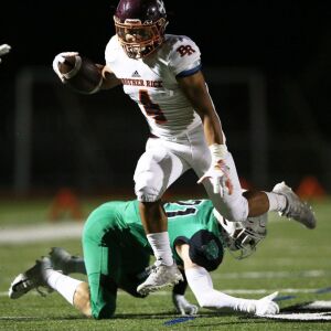 Brother Rice’s Jessi Plunkett (4) hurdles. Allen Cunningham/For the Sun-Times.