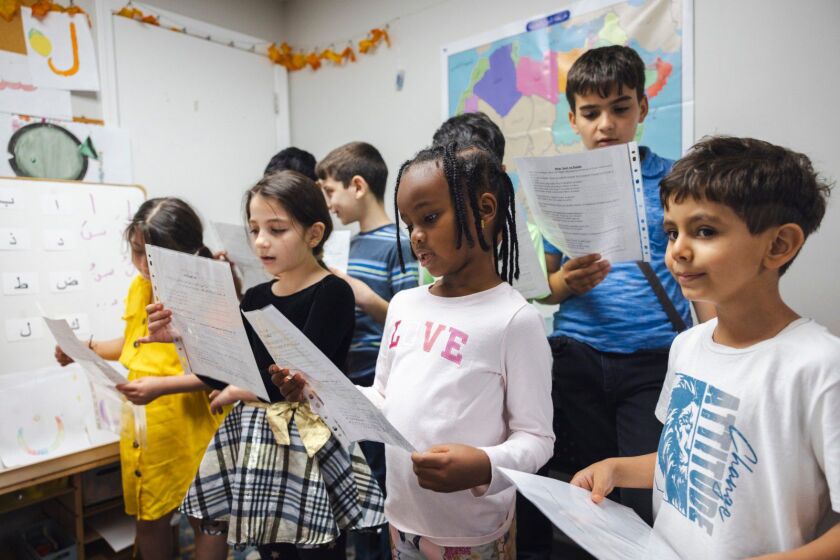 Students practice singing a song they will perform.