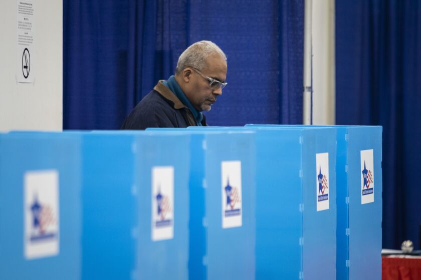On the first day of early voting, Edwin Reyes, 62, of Beverly, casts his ballot in the March 17 Illinois primary election at the new Loop super site at 191 N. Clark St., Monday morning, March 2, 2020.