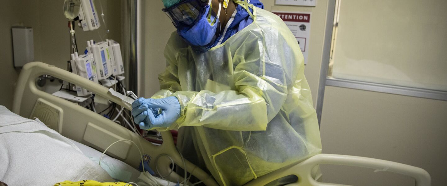 Nurse Tamara Jones checks blood sugar levels for a 73-year-old COVID-19 patient on a ventilator in the Intensive Care Unit at Roseland Community Hospital in December of 2020.