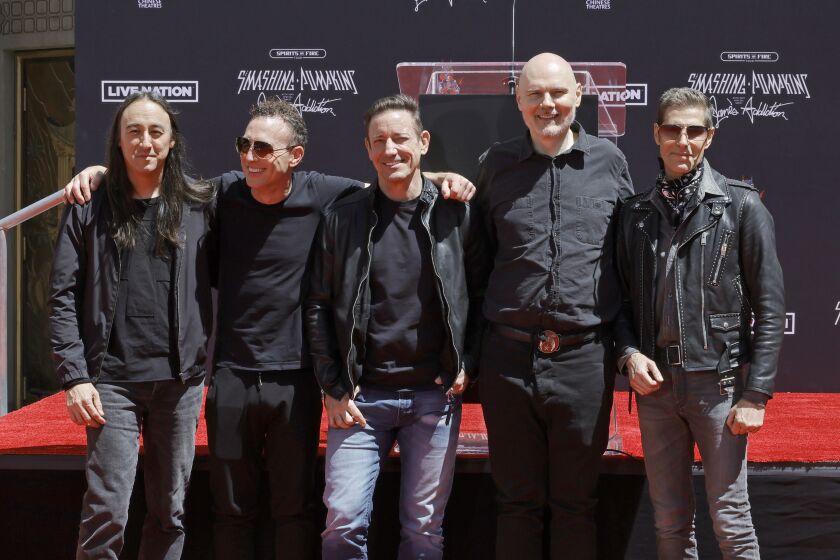Jeff Schroeder of The Smashing Pumpkins (from left), Stephen Perkins of Jane’s Addiction, Jimmy Chamberlin and Billy Corgan of The Smashing Pumpkins, and Perry Farrell of Jane’s Addiction attend the hand and footprint ceremony honoring The Smashing Pumpkins at TCL Chinese Theatre earlier this year in Hollywood. The two bands perform Nov. 5 at the United Center.