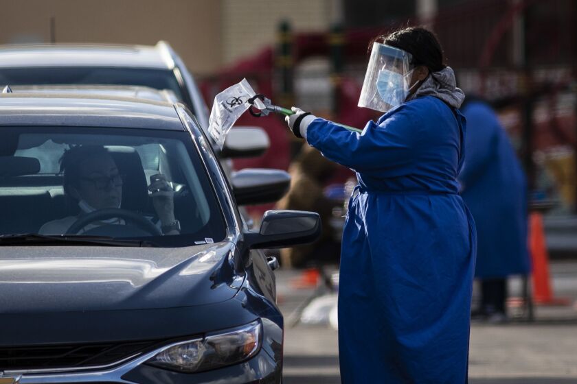 People get tested for COVID-19 at the drive-thru testing site at Maria Saucedo Scholastic Academy, 2850 W. 24th Blvd., in Little Village, Thursday afternoon, Oct. 14, 2020.
