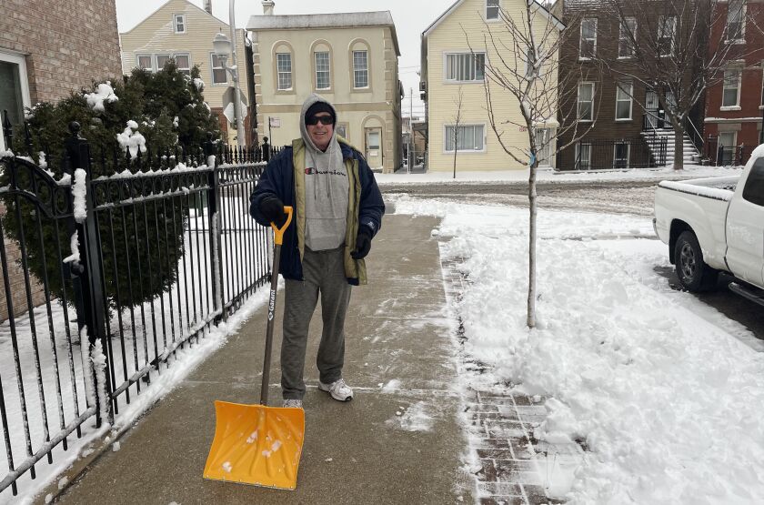 Ken Fronczak shovels in Bridgeport Friday morning near 29th and Throop streets.