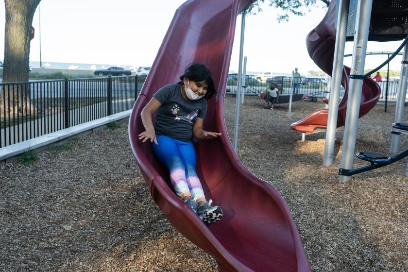 Celeste Hernandez, 8, a student at Franklin Fine Arts Center, slides down a slide at Lake Shore Park Playground in the Gold Coast neighborhood, Sept. 15, 2021.