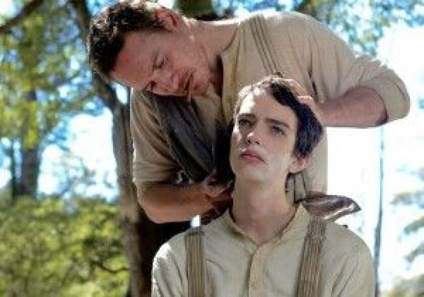 Silas (Michael Fassbender) gives Jay (Kodi Smit-McPhee) a shave in “Slow West.” | A24