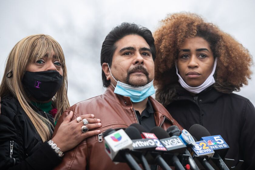Cynthia Chavez, the mother of Irene Chavez, puts a hand on her husband Daniel Chavez while their daughter Iris stands beside them during a press conference outside the 3rd District police station in the Park Manor neighborhood, Monday morning, Dec. 27, 2021, where friends and family demanded answers about Irene’s death.