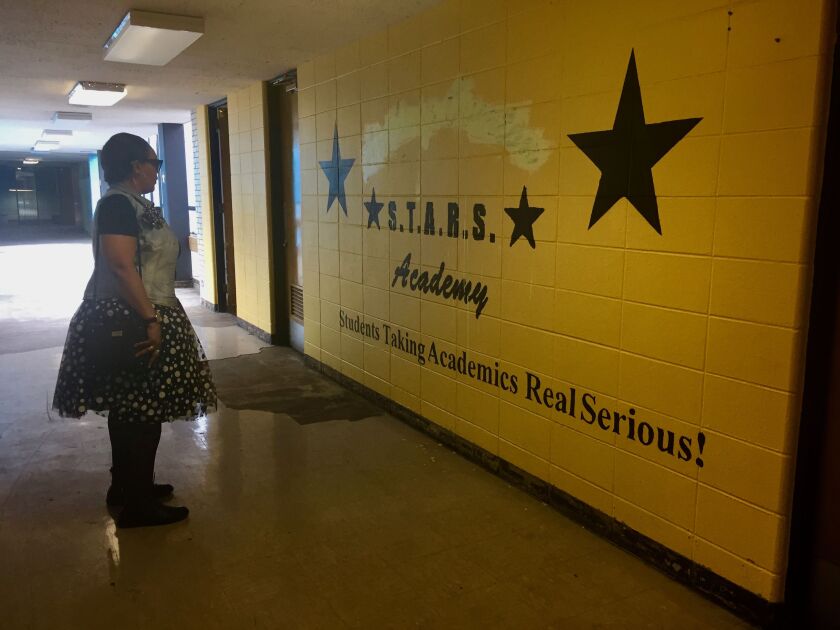 Linda Thomas, who taught at Overton for 15 years, gazes on an old mural at the school while touring the building. | Rachel Hinton/ Sun-Times