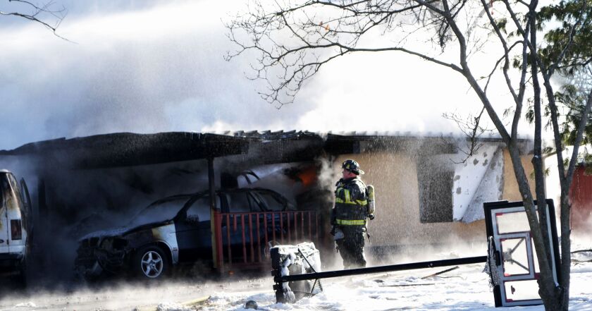 Firefighters battle a house fire that has injured one firefighter. | Justin Jackson/Sun-Times