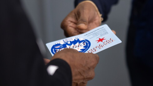 A woman receives an “I VOTED” sticker at the Dr. Martin Luther King Jr. Community Center polling site in Bronzeville on the South Side, Monday, Oct. 19, 2026.
