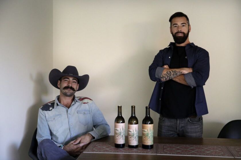 Alex Howe (right) and Chip Forsythe, co-founders of Rebel Coast, pose with their cannabis-infused wine in Los Angeles. Howe is planning high-end dinner parties in Los Angeles in early 2018 to debut the $59.99 bottle of wine. Each bottle contains 16 millig