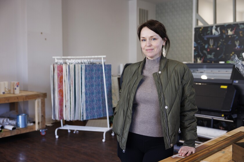 Erin Minckley stands in her textile design shop.