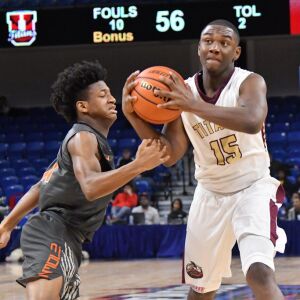 Evanston’s Jaheim Bolden (1) pokes the ball away from Uplift’s DeAndre Vortes (15). Worsom Robinson/For the Sun-Times.
