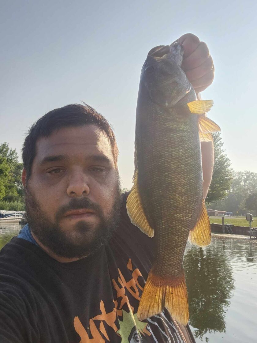 Vincent Rocco with the smallmouth bass of his double catch at Lily Bug Acres on the Chain O’Lakes. Provided photo