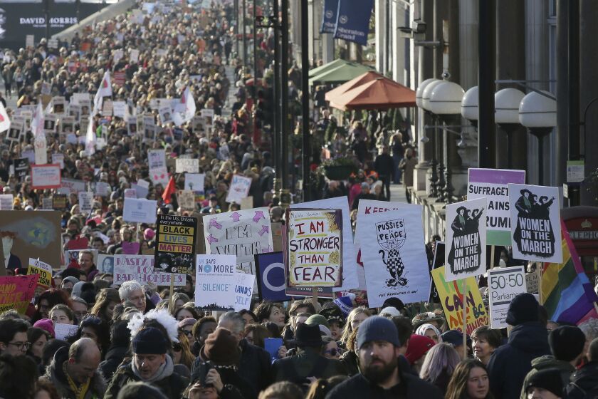 Demonstrators take part in the Women’s March on London Saturday. | Tim Ireland/Associated Press