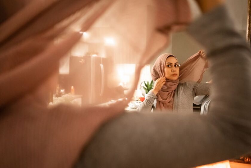 Felicia Salameh finishes putting on her headscarf at her Orland Park, IL home. She was raised in a Mexican-Muslim household and recently fully embraced Islam. | Maria de la Guardia / Sun-Times