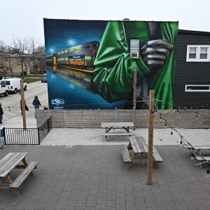 A mural by artist Asend is on a Highwood building.