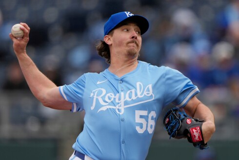 Kansas City Royals relief pitcher Hunter Harvey throws during the ninth inning of a game against the Cleveland Guardians on March 30, 2025, in Kansas City, Missouri,