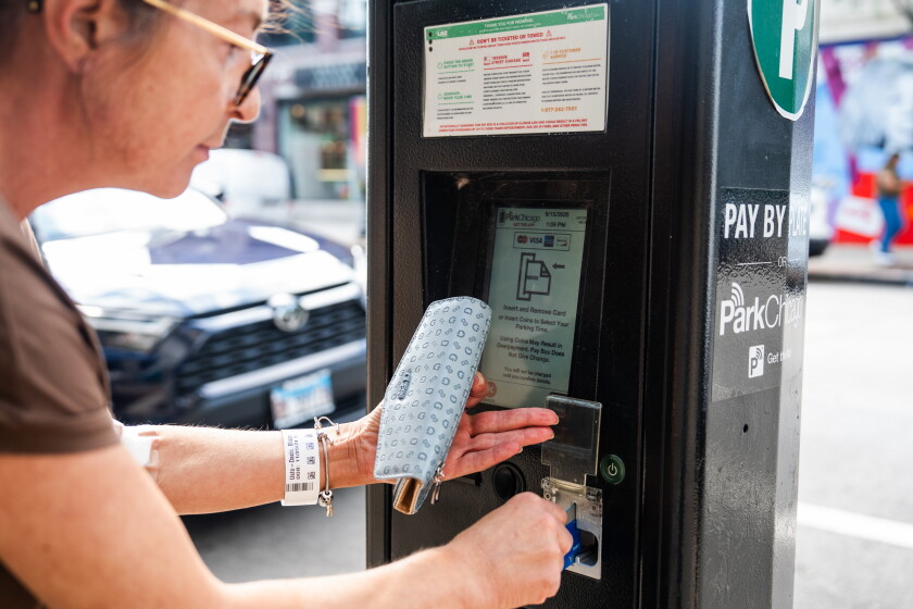 A driver pays for parking on ParkChicago’s parking meter on North Clark Street in Andersonville, Tuesday, Sept. 15, 2026.