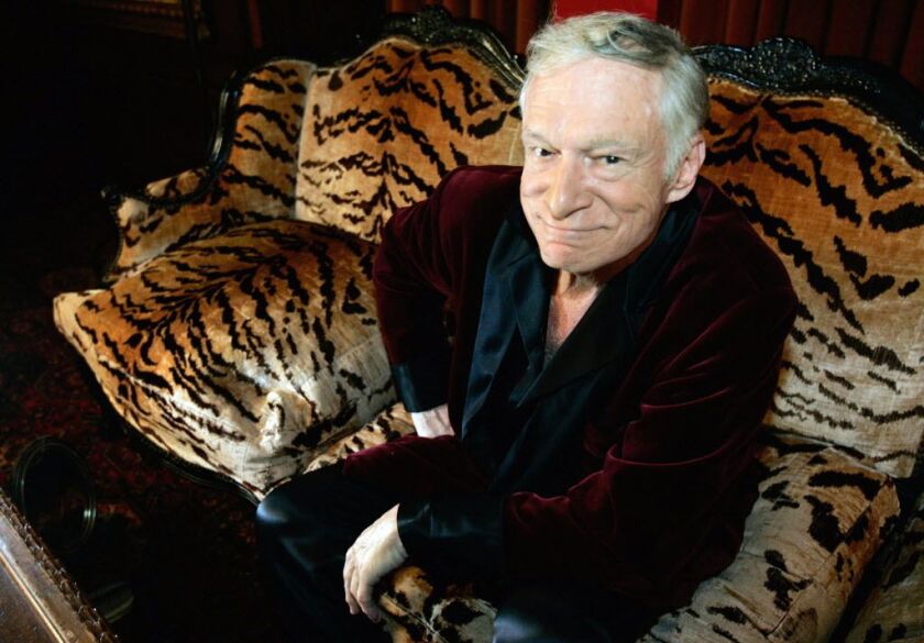 Hugh Hefner, CEO of Playboy Enterprises, poses for a photo during an interview with journalists at his mansion in Los Angeles, California on Aug. 23, 2006. | HECTOR MATA/AFP/Getty Images/File