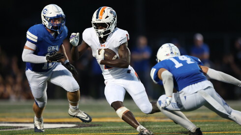 Oswego's Ammar Benire (2) cuts back a run to pick up more yardage against Geneva.