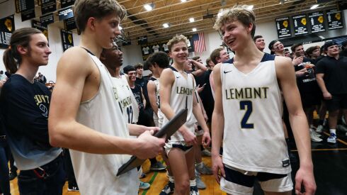 Lemont’s Nojus Indrusaitis. left, Matas Catillo, center, and Rokas Catillo, right, take a look at the sectional championship trophy.