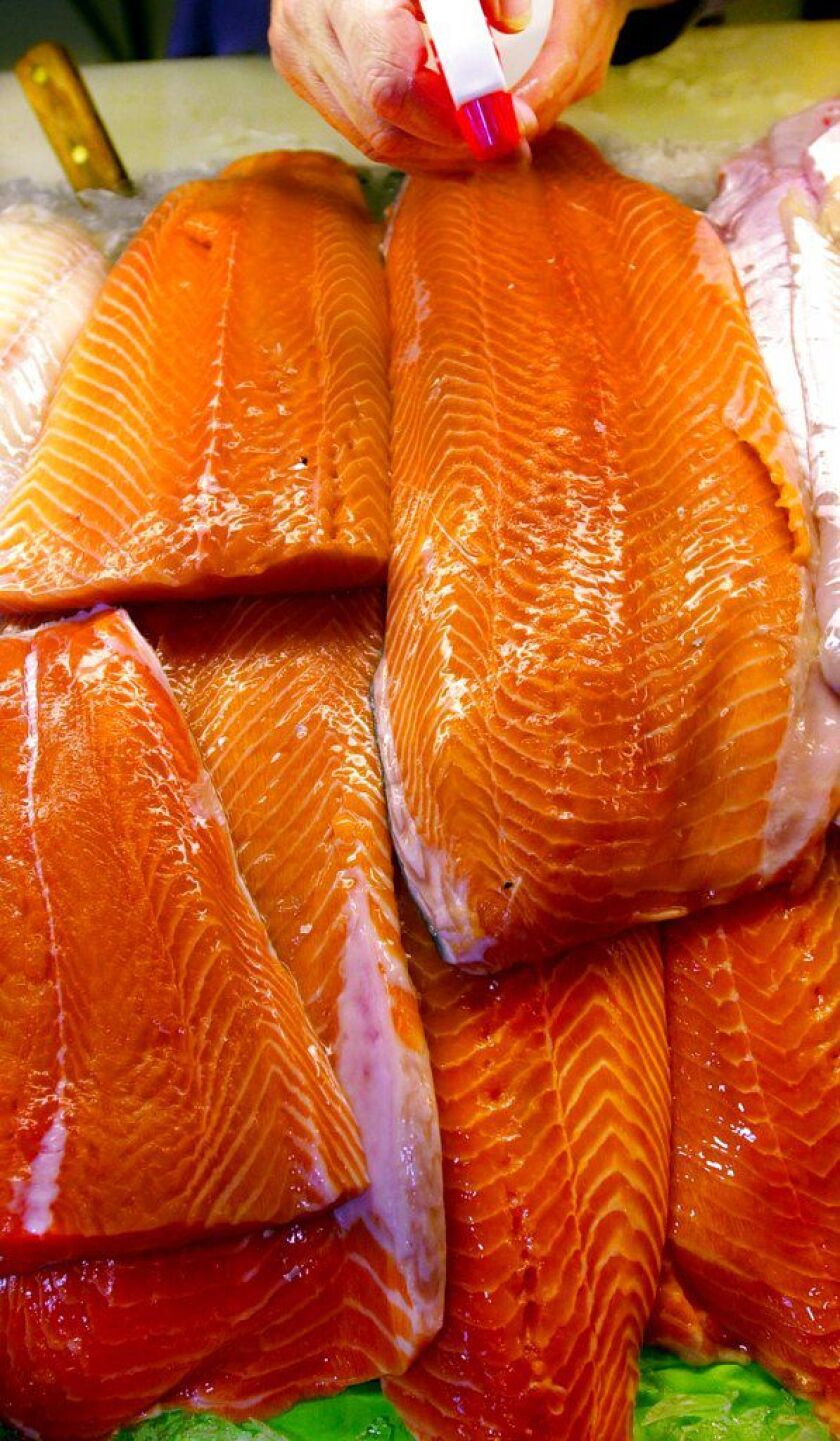 The Food and Drug Administration notes that manufacturers have to declare on labeling if color additives were used for salmon. | AP file photo