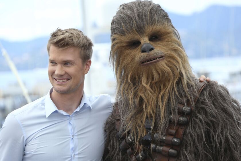 In this May 15, 2018 file photo, Finnish actor Joonas Suotamo poses with a person wearing a Chewbacca costume during a photo call for the film “Solo: A Star Wars Story'”at the 71st international film festival, Cannes. | Joel C Ryan/Invision/AP, File