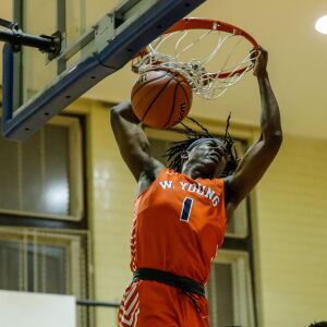 Young’s Sangolay Njie (1) dunks the ball against Lincoln Park.