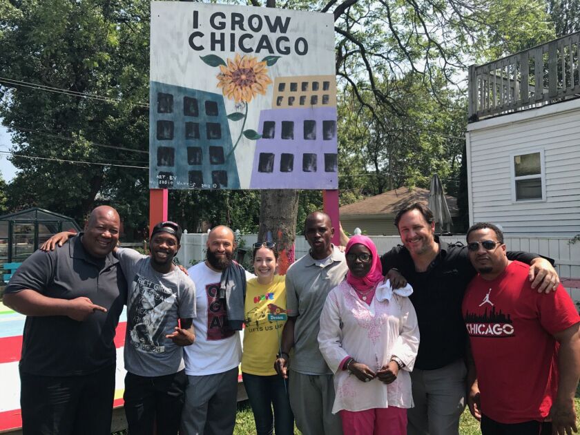 Marcus Robinson, left,managing director of Collaboraction Theatre, and Erin Vogel (in yellow shirt), co-executive director of I Grow Chicago, and supporters join Wu-Tang’s Tareef Michael (white shirt) and Oliver “Power” Grant (grey shirt). | Provided phot