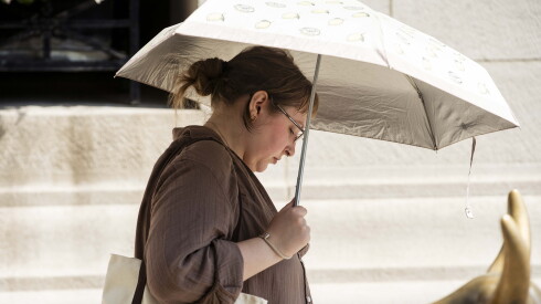 A pedestrian shades herself from the sun with an umbrella in the Loop on Tuesday, June 30, 2026.