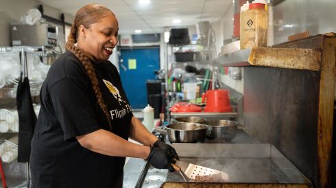 Linda Flippin, who owns/runs Flippin Flavors with her husband, Brian, cooks steak for a sandwich at their restaurant.