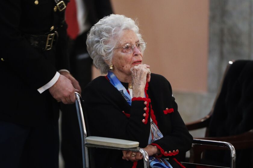 Annie Glenn arrives to view the casket of her husband, famed astronaut and U.S. Sen. John Glenn, as he lies in honor, in Columbus, Ohio, in 2016. Glenn died Tuesday of COVID-19 complications at age 100. 
