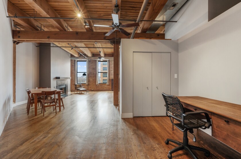 Entryway area with a desk to the right and views of the living room