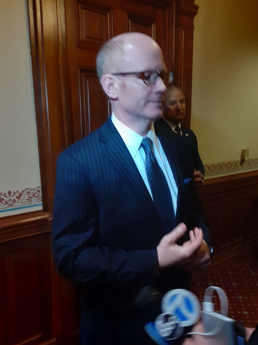 State Senate President Don Harmon talks to reporters in Springfield on Tuesday.