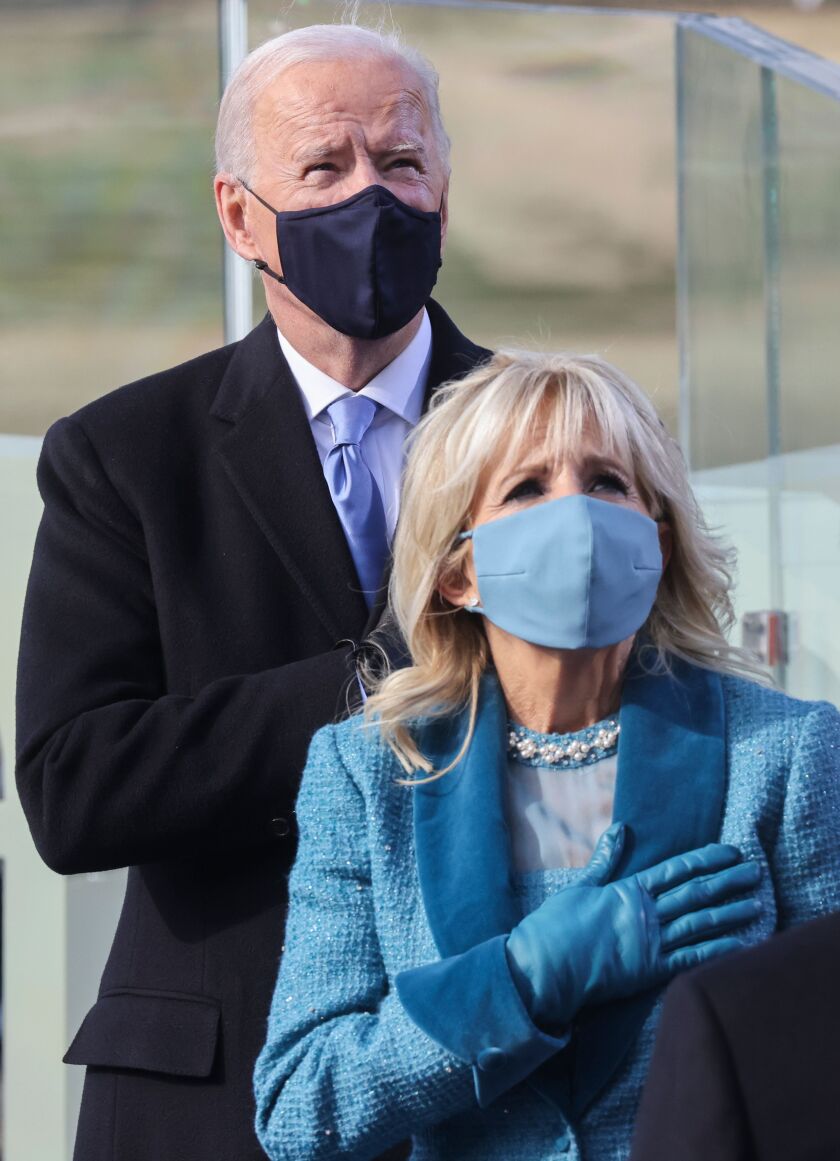 Joe Biden and his wife Jill Biden listen to the Pledge of Allegiance before he is sworn in as the 46th president of the United States on Wednesday.