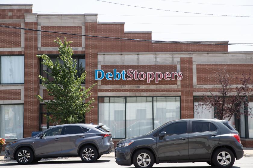 Cars drive past the DebtStoppers’ Chicago office at 11101 S. Western Ave.