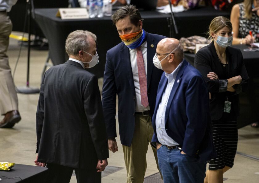 State Rep. Tim Butler, R-Springfield, center, talks with then House Speaker Michael Madigan, D-Chicago, left, and state Rep. Mike Murphy, R-Springfield, in May.