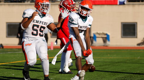 Morgan Park's Jaxon Bland (6) celebrates with Langston Waithe (55) after scoring against Kenwood in the Public League championship game at Lane Stadium.