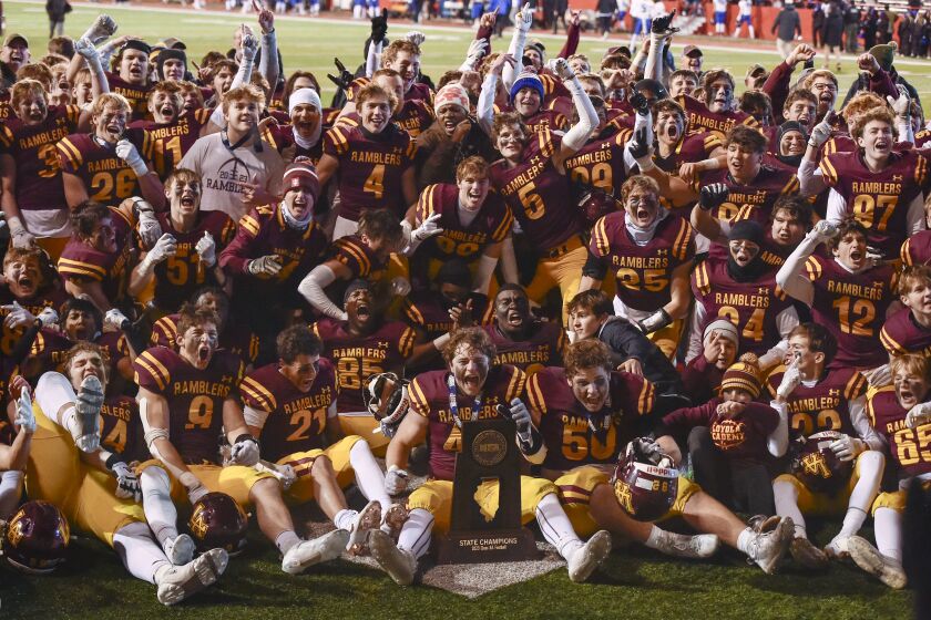 Loyola celebrates with the Class 8A state championship trophy after beating Lincoln-Way East.
