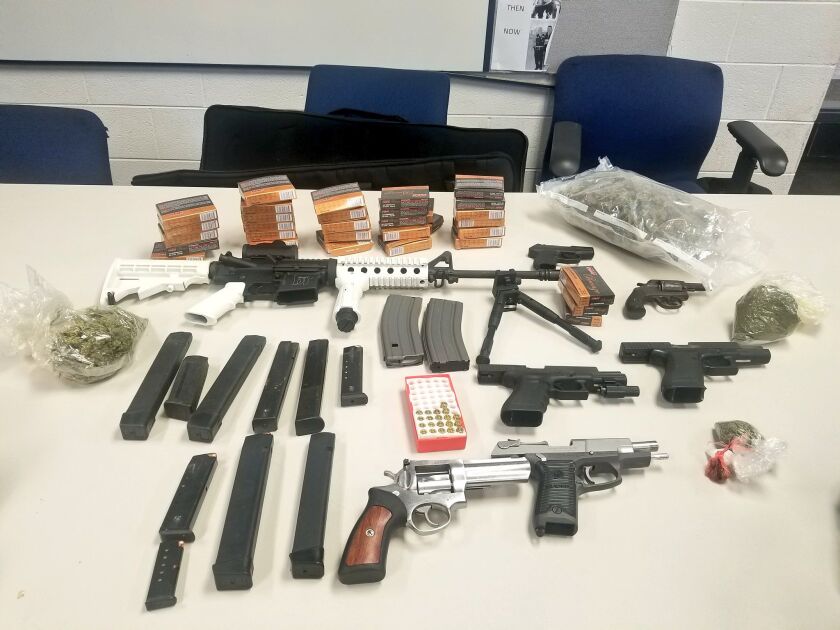 Officers found several weapons, ammunition, over 700 grams of marijuana and Oxycodone pills during a search of a home Wednesday in the 8700 block of South Ada. | Chicago Police