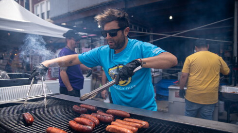 Chicago's Dog House owner Aaron Wolfson flips hot dogs at the Windy City Hot Dog Fest.