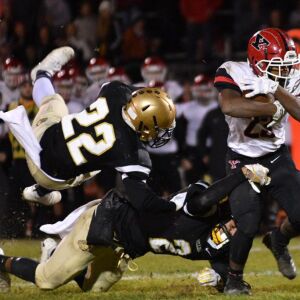 Yorkville’s Toran Harris (23) wraps up the ball. Worsom Robinson/For the Sun-Times.