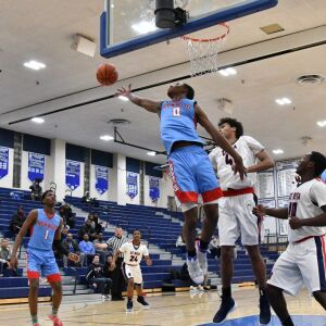 Seryee Lewis (0) of Kenwood reaches out for a rebound against St. Rita. Worsom Robinson/For the Sun-Times.