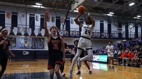 Oswego East's Mason Lockett (24) shoots a jumper against Oswego.