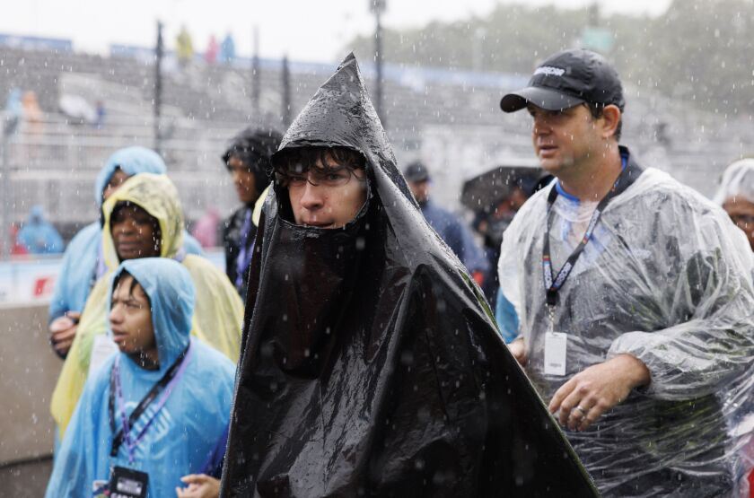 Fans endure the pouring rain prior to the Grant Park 220 NASCAR Street Race, Sunday, July 2, 2023.