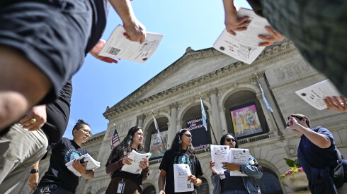 Members of the Art Institute of Chicago Workers United prepare to pass out informational flyers outside of the Art Institute of Chicago along Michigan Avenue.