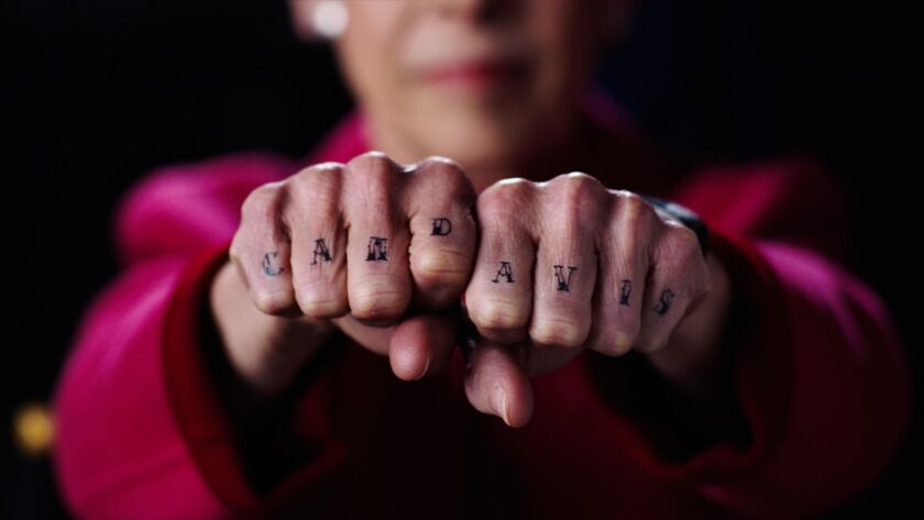 Commissioner Debra Shore shows her Cam Davis “tattoo” in a campaign spot for Davis during the primary.