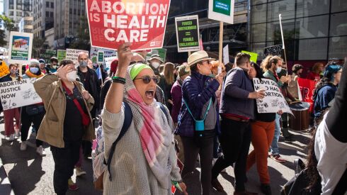 Hundreds of pro-abortion advocates march along South State Street in the Loop during the nationwide Women’s Wave Day of Action, aiming to encourage people to vote for candidates who support abortion in the midterm elections, Saturday, Oct. 8.