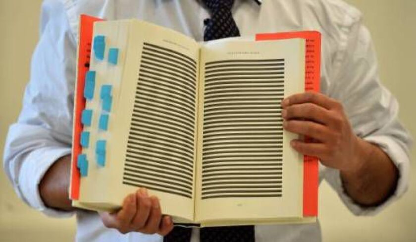 The younger brother of Mohamedou Ould Slahi, poses with a copy of Mohamedou’s prison memoir ‘Guantanamo Diary’ open to show pages that were redacted by the US government. The family and supporters of “one of the most abused prisoners in Guantanamo” launch